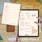A digital weekly journal planner shown on a tablet screen and an open paper-style page, with hands holding the tablet and a white stylus on a wooden desk. Text reads 'ALM23 Low-Pressure Weekly Digital Journal' and '2027 + 2026 Part 2'.