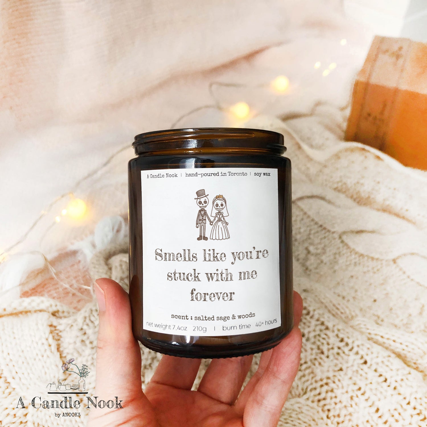 Hand-poured soy candle with a skeleton couple illustration and the phrase 'Smells like you're stuck with me,' perfect for wedding or anniversary gifts.